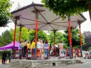 Viva choir sings in bandstand in park