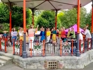Viva choir sings in bandstand in park
